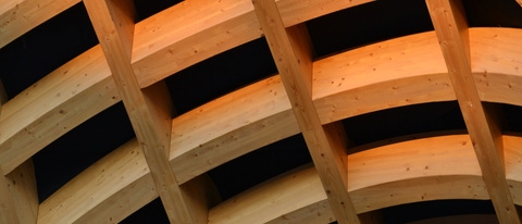 Big solid wood intersection support structure for arch entrance.